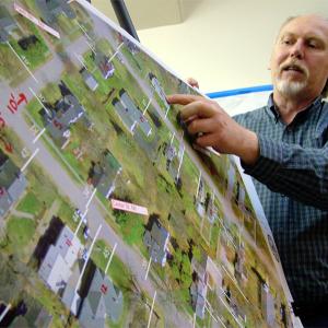 City Planner Wayne Marshall with detail from a map listing setback distances for all properties inside the bypass. These vary from streets where homes practically abut the road, to others where 50-foot-deep front lawns are the norm. One of several new zoning proposals would allow variable setbacks based on existing buildings. (Photo by Ethan Andrews)