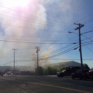 A fire that started in the basement of Redlon & Johnson on Tillson Avenue in Rockland sent plumes of black smoke into the air Sunday morning, June 22. (Photo by Lynda Clancy)