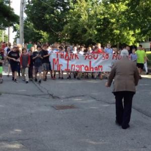 Camden-Rockport Middle School Interim Principal Thom Ingraham stands before the ‘flash mob’ of students parading a banner down Knowlton Street Monday morning.
