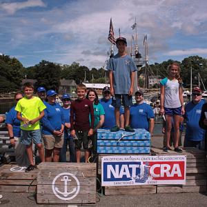 Winners of the 2014 Camden Windjammer Festival Lobster Crate Race stand atop the crate podium Saturday. Taking first place was Emerson Brott, 288 crates, second place went to Lauren Rothwell, 286 crates, and there was a tie for third place between Jonah Lovejoy and Luke Drinkwater, who both tallied 270 crates. (Photo by Holly S. Edwards)