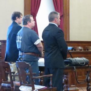 Todd Gilday stands with his public defenders to hear his sentence. (photo by Erica Thoms)