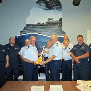David W. Cassida, center left, of Belfast, is awarded the U.S. Coast Guard Auxiliary Membership Paddle for 45 years of service at a ceremony held Aug. 15 at U.S. Coast Guard Station Rockland on Tillson Avenue.