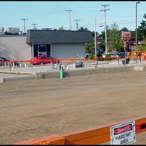 The foundation of a new Dunkin Donuts building now occupies the former parking lot to the south of the soon-to-be-replaced Dunkin Donuts store. (Photo by Ethan Andrews)