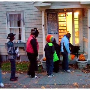 Daylight trick-or-treaters line up outside a house on Cedar Street. (Photo by Ethan Andrews)