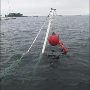 The mast of the sunken boat in Camden Harbor. (Photo by Chris Wolf)