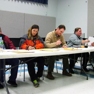 RSU 20 board members sign off on the Nov. 4 election results, which included the withdrawal of six of the district’s eight towns. From left, Deborah Riley of Northport, Denise Dakin of Stockton Springs, Dustin Nadeau of Searsport, and Caitlin Hills and Wayne Corey of Belfast. (Photo by Ethan Andrews)