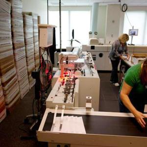 Athenahealth workers sort mail in the Remittance Processing department at the company’s Belfast offices. (Photo courtesy of athenahealth)