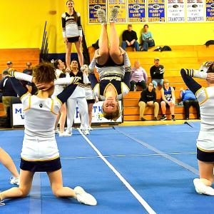 Cassidy Dever, center, flies out with some outstanding tumbling to get the crowd into the routine. (Photo by Ron Hawkes)