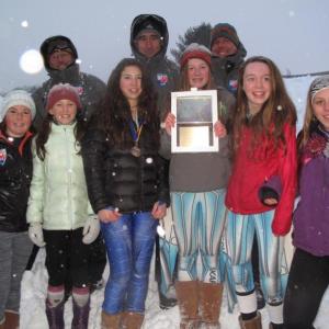 The Camden Snow Bowl middle school girls ski state champions! Front row, from left, are Courtney King, Isabelle Manahan, Vika Santoro, Sydney White, Annabelle Williams and Jesi Mann, as well as their coaches. Missing from the photo are Molly McClellan and Ella Ardizoni. The coaches are, from left, Mike Bridges, Weber Roberts and Mike White. (Courtesy Lori Traikos)