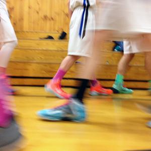 The boys on Searsport’s varsity basketball squad have mostly ditched “team shoes” in favor of bright colors. These got an extra boost at a Feb. 5 home game, pictured, when the team added pink socks and laces for breast cancer awareness. (Photo by Ethan Andrews)