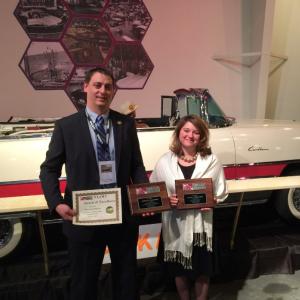OHTM Auction and Event Coordinator Toby Stinson (left) and OHTM Volunteer Coordinator Niki Janczura show off three NAAM awards presented to the Museum at the National Association of Automobile Museums annual conference at the National Packard Museum in Warren, OH.