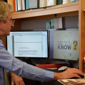 Rockport Town Manager Rick Bates at his office desk, where the hookup to fiber cable last year is now providing him with Internet download and upload speeds of 796 megabytes per second. (Photo by Lynda Clancy)