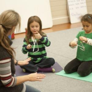 Instructor Jessica Day introduces percussion to children.