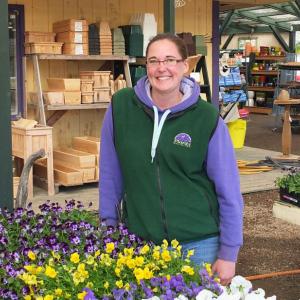 Emily Buck, general manager of Plants Unlimited, stands with some of the pansies. (Photos by Chris Wolf)
