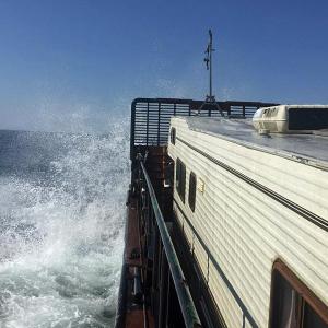 Riding the waves between Monhegan Island and Provincetown, Mass. yesterday is a 1987 Winnebago American Cobra camper aboard a 1966 steel barge called ‘Clam.’ (Courtesy Steve Pixley)