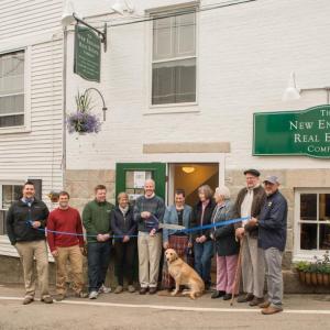 Celebrating New England Real Estate's new Bay View Street office in Camden are, from left: Erick Anderson, Camden Downtown Business Group President; Tyler Smith, Bay View Management; Dan Bookham, Allen Insurance; Karen Brace, Penobscot Regional Chamber of Commerce; A. Flint Decker, President & Founder of The New England Real Estate Co.; Gail Marie Decker, canine Annie Decker; Patricia Finnigan, Camden Town Manager; Naomi M. Decker, Charles M. Decker, David Robichaud.