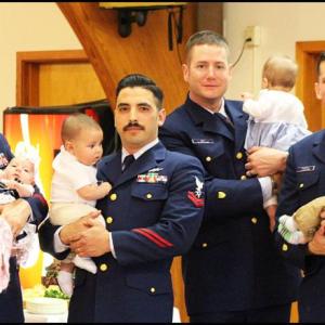 Being in the Coast Guard does not get you out of Dad duty. From left to right MK1 Dettmer with daughter Josephine; FS2 Loya with son Jethro; BM2 Veit with daughter Mary; and BM1 Ramirez with son Hudson. (Photo by Ellie Curtis)