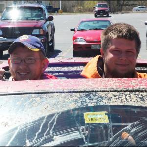 Owen Winchenbach, of Thomaston, and Ryan Maloney, of Cushing, peak their heads up through the sunroof of their mud-caked car. (Photos by Chris Wolf).