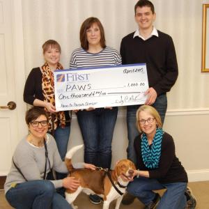 The First presents a sponsorship check to P.A.W.S. From left, in back: Knox County Banking Associates Karli Schroeder, Angie Parent and Daniel Hart. In front: P.A.W.S. Executive Director Amie Hutchison, Charlie and Knox County Banking Associate, Sue Ferrier. (Photo courtesy Nancy Albertson)