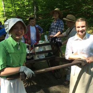 Eliza Crowley and Courtney Harrington pull a loaded handcart through the Camden Hills. (Photo credit: Jeff Thomas)