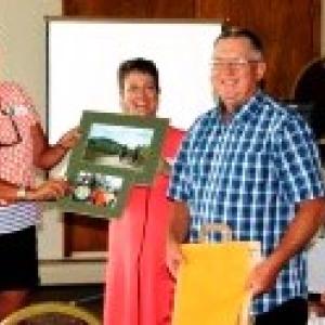 New GPMCT President Emily Hawkins and Executive Director Cheri Domina present Bob Gomes with Volunteer of the Year award. (Photo courtesy Hans Krichels)