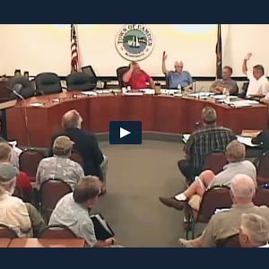 From left, John French, Don White and Martin Cates raise their hands and vote in favor of putting piers in the outer harbor back into the Harbor Ordinance during Tuesday night’s public hearing. Leonard Lookner and Jim Heard were opposed. (Townhallstreams.com screen shot)