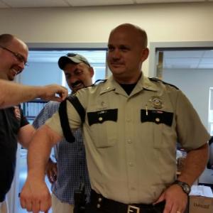Knox County Deputy Paul Spear and Sgt. Lance Mitchell apply a combat application tourniquet to Chief Deputy Tim Carroll. (Photo by Sarah Shepherd)