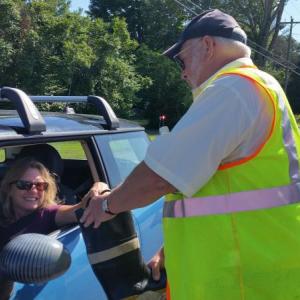 Firefighter Allen Mitchell is filling his boot with donations on Route 90. (Photo by Sarah Shepherd)