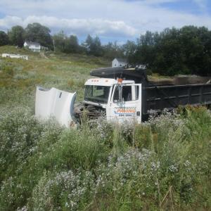 Elisabeth Bormet, 33, of Belfast, was driving this Freightliner dump truck Tuesday afternoon when she said her thumb became entangled in the truck’s steering wheel cover, causing her to lose control and crash (Courtesy Waldo County Sheriff’s Office)
