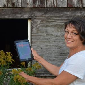 Annie Kassler and bat spectrometer investigate an old Rockport barn. (Photo by Lynda Clancy)