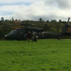 Appalachian Trail hiker Gabriel Grace, of Baltimore, Md., is assisted away from the Maine Air National Guard helicopter by a Blackhawk crew member. (Courtesy Maine Warden Service)