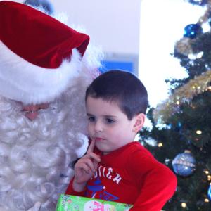 Some of the Coast Guard children knew exactly what they wanted for Christmas when they saw the Flying Santa Sunday at the Maine Lighthouse Museum, and they knew what it cost and where to get it. Others, had to think a little bit... (Photo by Holly S. Edwards)