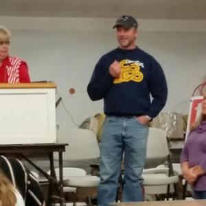 David Leighton, with his wife Lisa, addresses the room full of supporters at his benefit dinner, held in October. Linda Payson, left, lead the crowd in the live auction. (Photo by Sarah Shepherd)