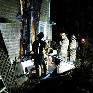Fire heavily damaged the side of the home at 30 Winding Way in Rockport Saturday night, while Rockport firefighters worked to put it out with help from Camden, Rockland and Hope fire departments. (Photo by Sarah Shepherd)