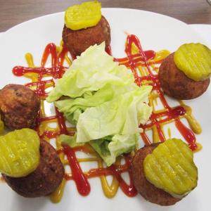 Fried cheeseburger balls with drizzles of ketchup and mustard, a $3 deal on the World Cafe’s American menu. (Photo by Kay Stephens)