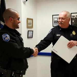 Rockland Police Chief Bruce Boucher congratulates Officer Alex Gaylor who was selected as the department’s officer of the year for 2015. (Courtesy Rockland Police Department)