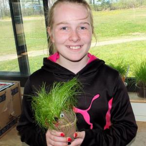 Michaela Smith shows off her Chia Pet she grew in the classroom.