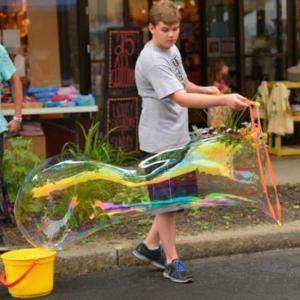 Family fun with giant bubbles during the 2013 Summer Solstice Celebration in downtown Rockland. (Photo by Ron Hawkes)