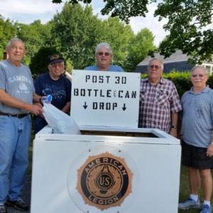 Frank Carr, American Legion Post 30 Commander, Kip Stinson, member, Jeff Sukeforth, Adjutant, Cecil Dennison, Service Officer and John Hyssong, member, stand with the organization’s new returnable collection box. Proceeds from the recycling program will benefit the Legion’s community projects. (Photo by Sarah Shepherd)