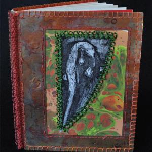 ‘Dire Cation,’ (2016), hand-hammered copper, marbled paper and etching with silk stitching, 14 pages.
