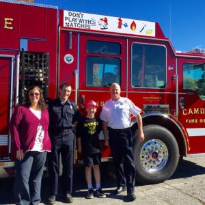 The fifth-grade winner of the Camden Fire Department’s fire safety logo art program is Ryan Andersen, a student at CRMS. Pictured with Andersen is Jaime Stone, principal at CRMS, firefighter Matt Heath and Camden Fire Chief Chris Farley. (Photo courtesy of Jaime Stone)