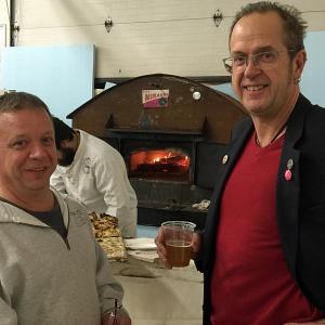 Right, chef Kerry Alterio and his portable wood fire pizza oven at the 2014 P.A.W.S. Auction for the Animals, with Joe Ryan of Adventure Advertising and a P.A.W.S. board member. (Photo by Holly S. Edwards)