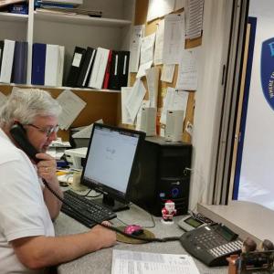Jeff Sukeforth, program coordinator for Good Morning Camden, is busy on the phone making his daily outreach calls to the seniors registered in the program. (Photo by Sarah Shepherd)