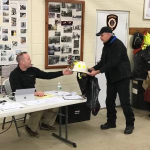 Rockport Deputy Fire Chief Todd Philbrook presents Fire Chief Jason Peasley with a custom-made Chief’s helmet, at their regular monthly meeting, to recognize his leadership since 2013. (Photo courtesy of Rockport Fire Department)