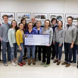 Accepting the $1,000 donation from First National Bank are, front row, left to right: Nordic Team Captains Maddison Jordan, Marley O’Neil, Erin Dowd, Emily Bowen, Lucy Hayward; Cross Country Team Captains Emma Trapani, Mallory Caron, Caleb Love-Webb, Nick Doran. From First National Bank in the back row from left to right: Angie Parent, Branch Supervisor in Rockport, Jake Miller, VP Business Development Officer Knox County, Angie Sabins, Assistant Manager in Camden, and Jennifer Stewart, Senior Vice President, Retail Lending.