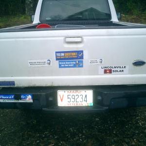 Some people love putting their political persuasions and other enthusiasms on the bumper of their vehicle. We always replenished ours every fall at the Common Ground Fair’s Political Action tent. (Photo by Diane O’Brien) back of truck