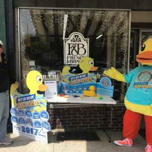 West Bay Rotarian Peter Berk and Lucky the Duck selling Duck Derby tickets outside French & Brawn in Camden.