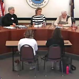 Candidates facing the audience, from left, Steve Beveridge, Robert Falciani, Alison McKellar, Don White and Christian Wincklhofer. Seated in front of them, backs to the camera, Kim Lincoln on the left and Lynda Clancy on the right.