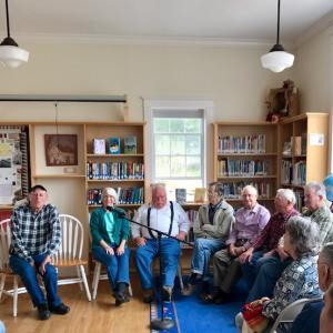 The story-tellers sitting around at the Library Sunday afternoon – l-r: Rosey Gerry, Rosemary Winslow, Sandy Delano, Orvil Young, Allan Thomas, Joe Calderwood, and Bernard Young.
Photo by Cheryl Wienges story telling 4/30