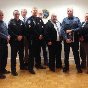 Rockport selectmen, with Camden and Rockport police officers, honor Travis Ford May 8 in Rockport. From left to right: Rockport Select Board member Owen Casas, Selectman Geoff Parker, Rockport officer Chris Taylor, Camden officer Tim Davis, Rockport Town Manager Rick Bates, Camden Police Sgt. Dan Brown, Rockport Select Board Chairman Bill Chapman, Rockport Police Sgt. James Moore, Rockport Police Officer Travis Ford, Camden-Rockport Police Chief Randy Gagne, and Camden Police Sgt. John Tooley.